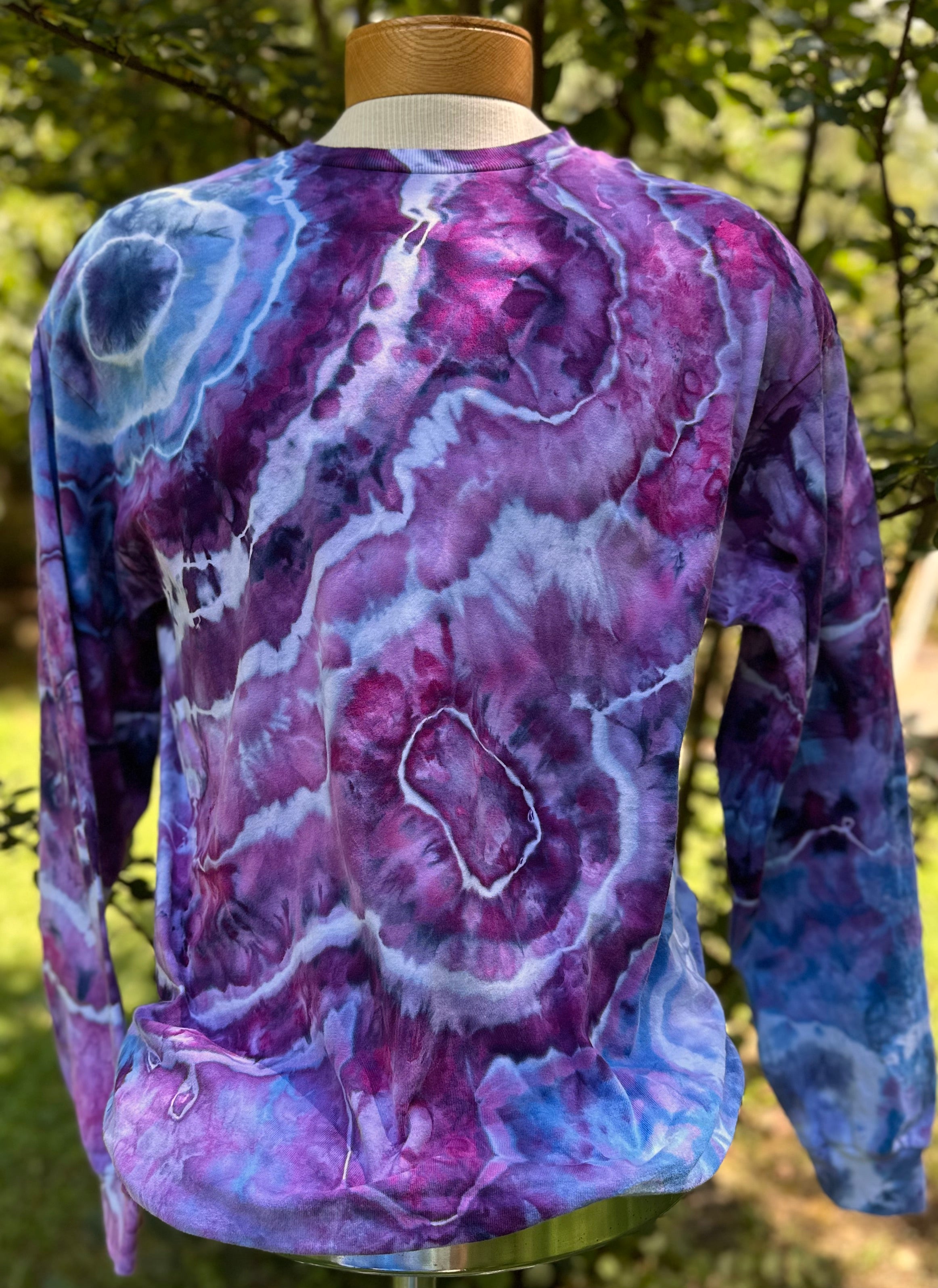 Purple tie-dye long-sleeve shirt on a mannequin with a natural background